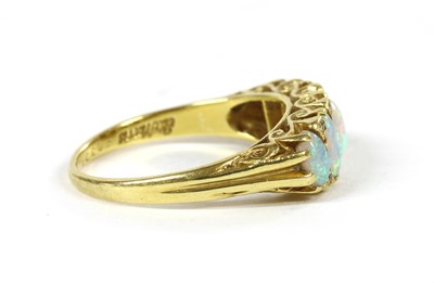 Lot 205 - An 18ct gold five stone opal carved head style ring