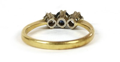 Lot 198 - A gold three stone sapphire and diamond ring