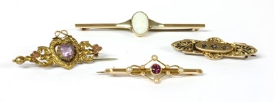 Lot 57 - A gold garnet and split pearl bar brooch