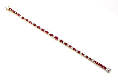 Lot 402 - A ruby and diamond graduated line bracelet