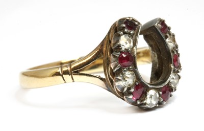 Lot 33 - A gold and silver, diamond and ruby, horseshoe ring
