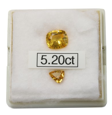 Lot 447 - An unmounted cushion cut yellow sapphire