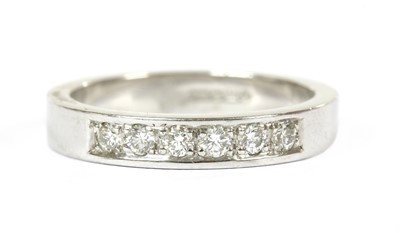 Lot 230 - A 9ct white gold diamond half eternity ring
