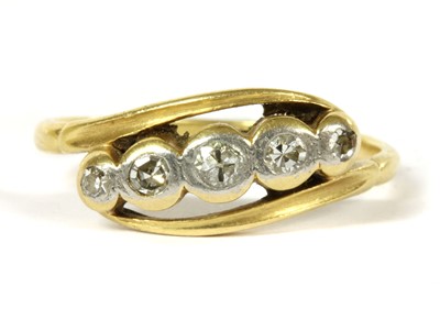 Lot 172 - A gold five stone diamond crossover ring