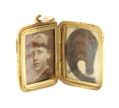 Lot 60 - A late Victorian gold rectangular cushion-shaped hinged locket