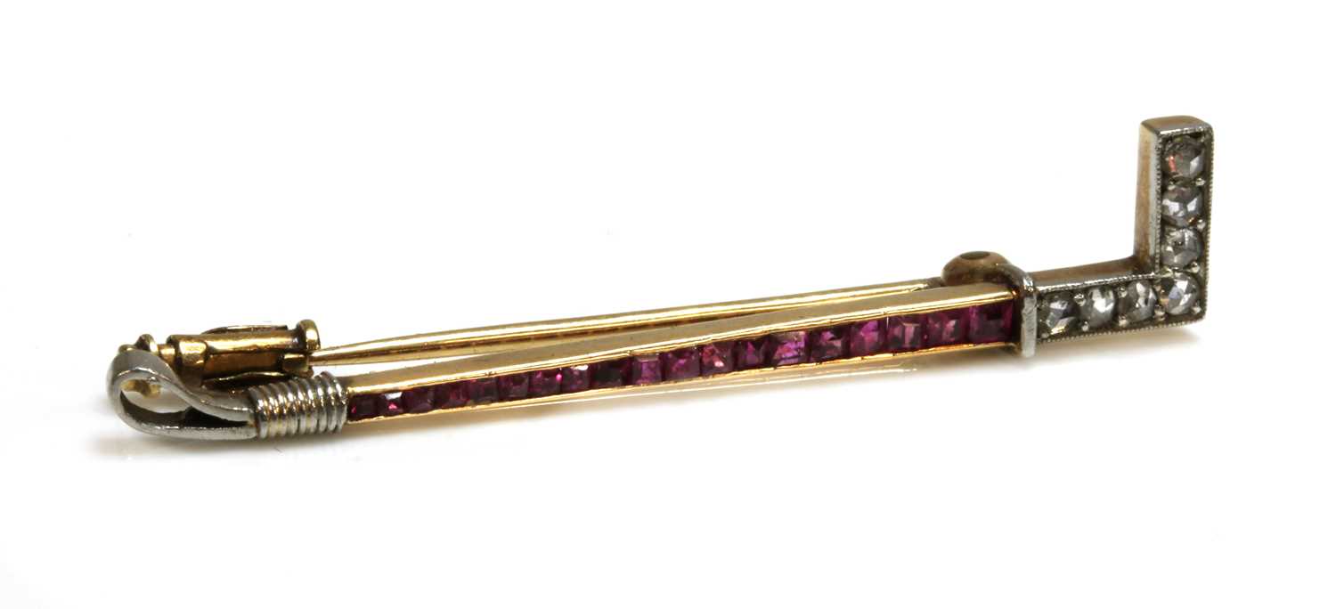 Lot 155 - A Continental Art Deco ruby and diamond hunting crop bar brooch