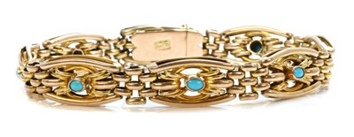 Lot 90 - An Edwardian gold and turquoise set gate bracelet