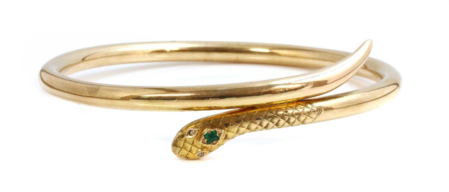 Lot 72 - An early 20th century gold emerald and diamond set serpent or snake bangle