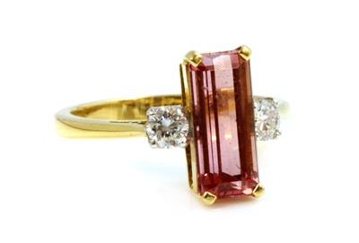 Lot 305 - An 18ct gold topaz and diamond three stone ring