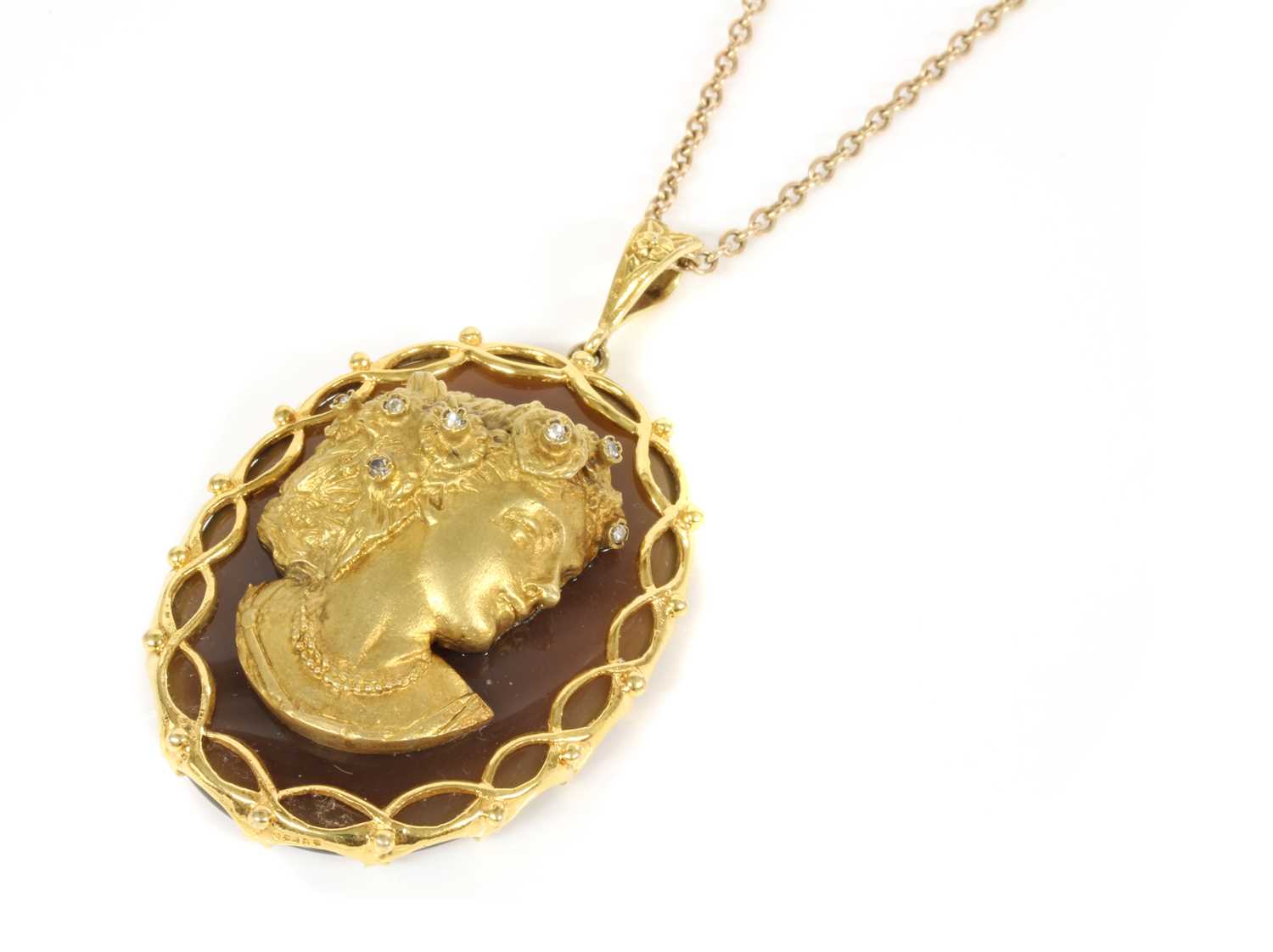 Lot 185 - A 9ct gold diamond set profile or cameo habillé-style agate pendant, c.1970