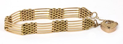 Lot 304 - A gold five row gate bracelet