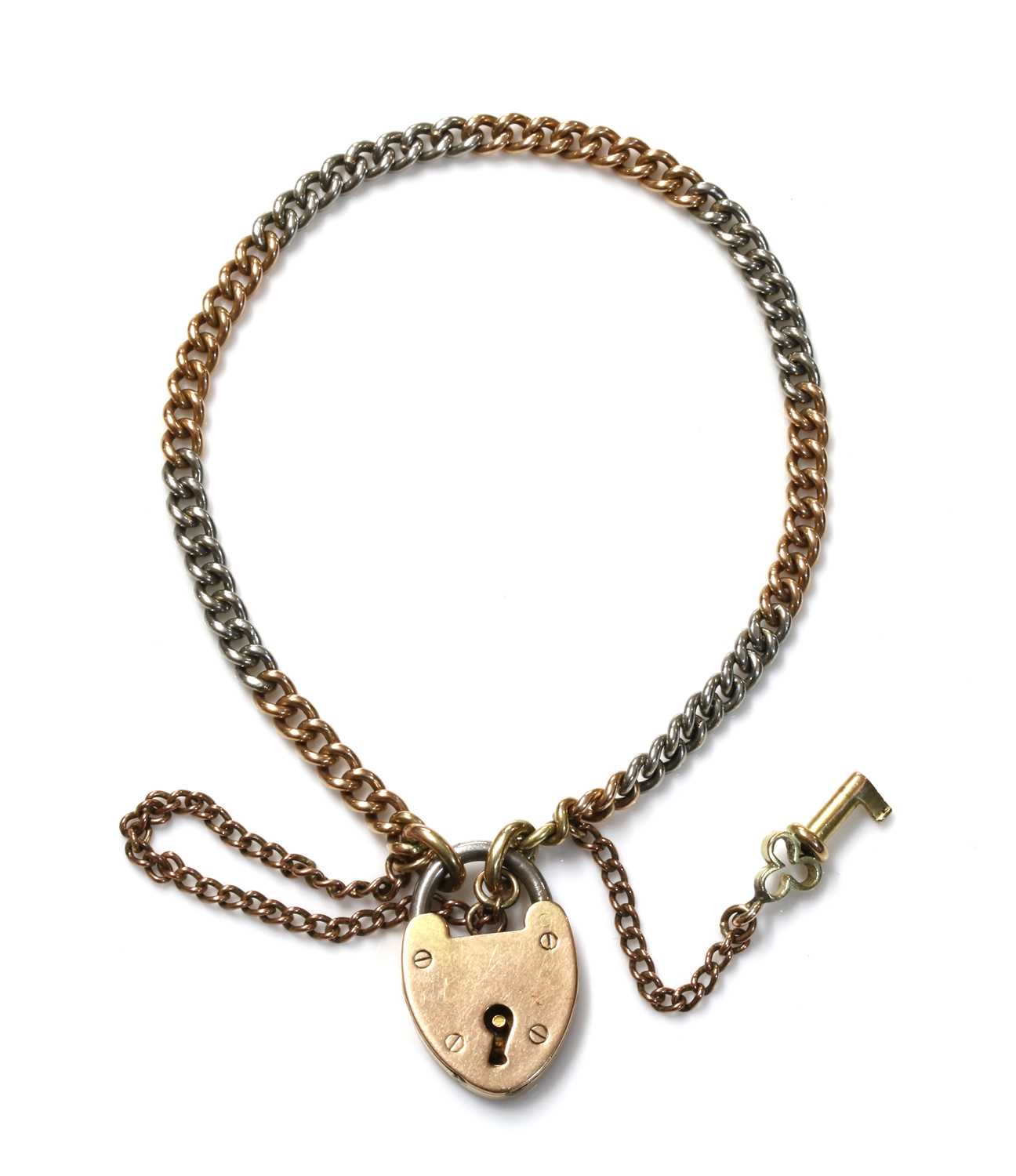 Lot 158 - A two colour gold and platinum curb link bracelet, c.1920