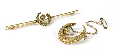 Lot 50 - A gold diamond and emerald crescent bar brooch