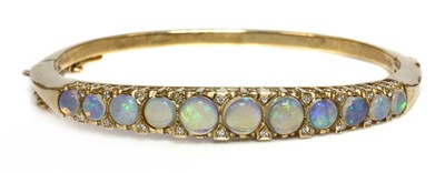 Lot 105 - A 9ct gold opal and diamond hinged bangle