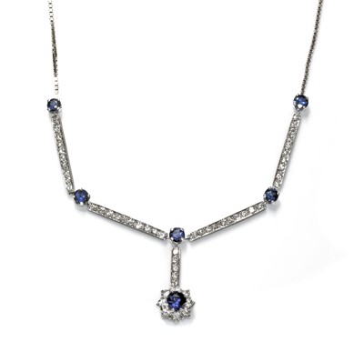 Lot 454 - An 18ct white gold sapphire and diamond cluster necklace, c.1970