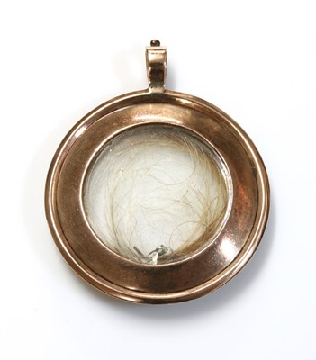 Lot 16 - A Georgian gold and paste set circular glazed locket