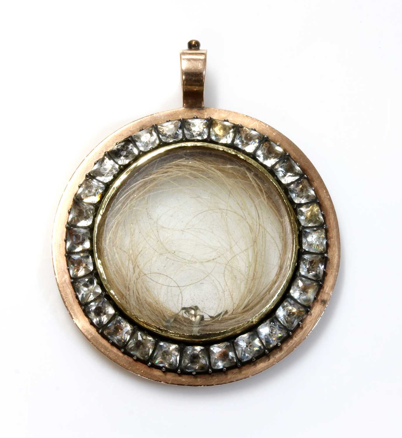 Lot 16 - A Georgian gold and paste set circular glazed locket