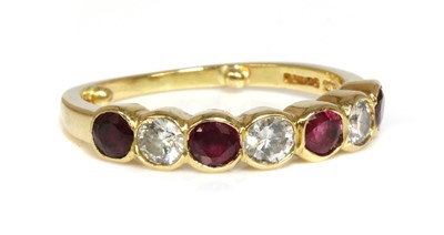 Lot 406 - An 18ct ruby and diamond half eternity ring