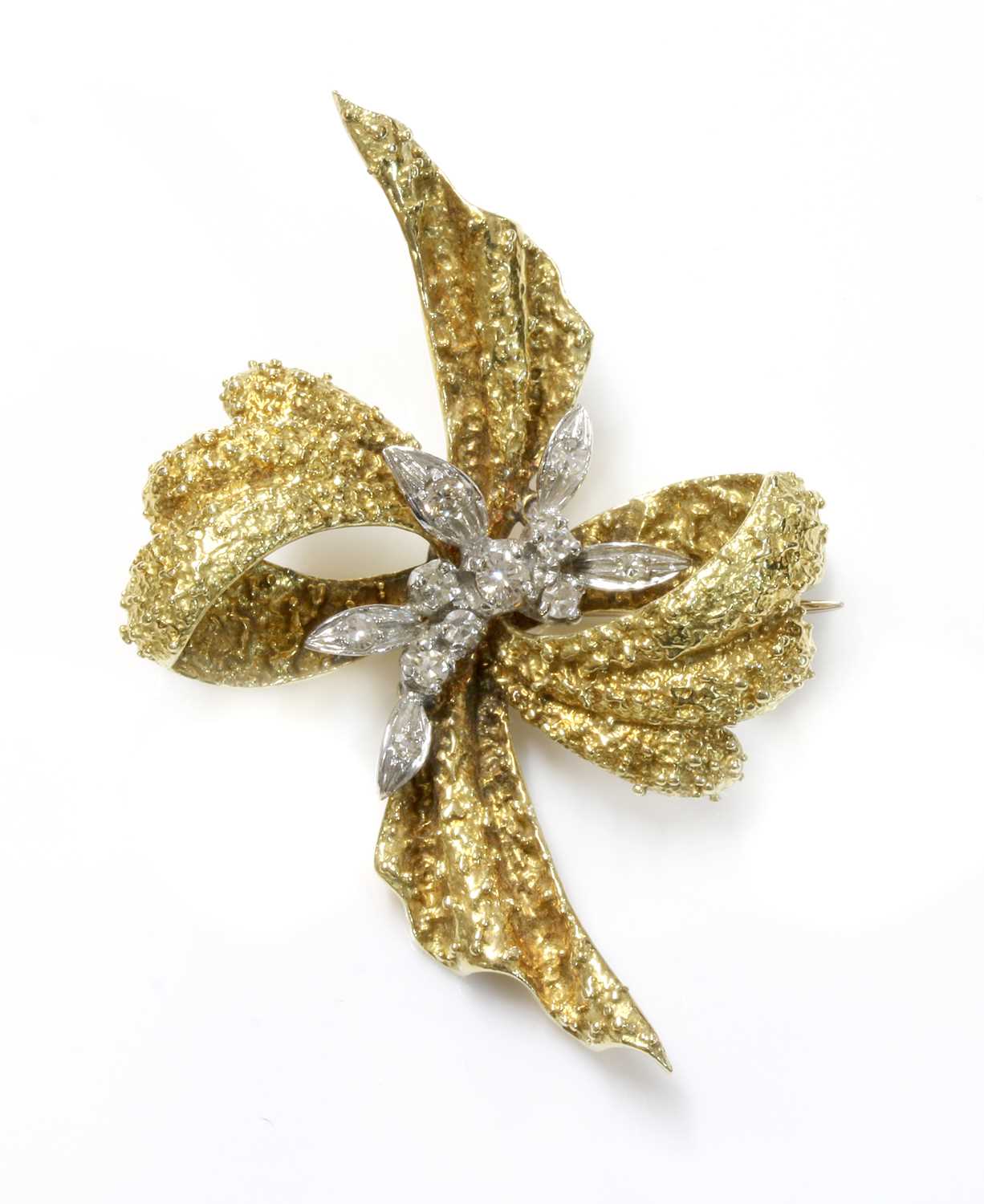 Lot 161 - An 18ct yellow and white gold diamond set bow brooch, c.1970
