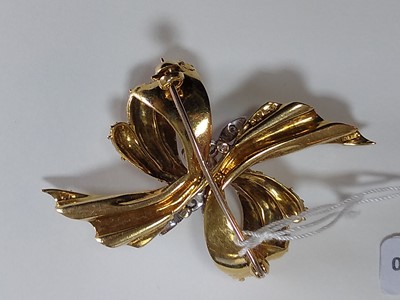Lot 161 - An 18ct yellow and white gold diamond set bow brooch, c.1970