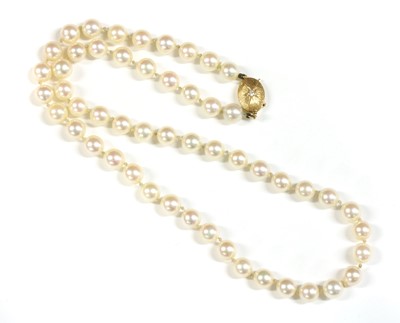 Lot 69 - A single row uniform cultured pearl necklace with gold diamond clasp