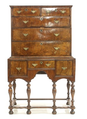 Lot 544 - A walnut chest on stand