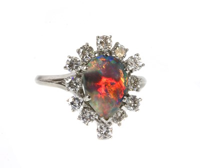 Lot 103 - A black opal and diamond pear-shaped cluster ring