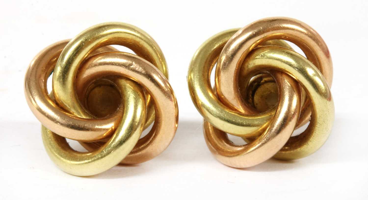 Lot 292 - A pair of gold and rose gold knot stud earrings