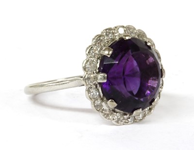 Lot 100 - A platinum amethyst and diamond cluster ring