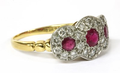 Lot 164 - An 18ct gold ruby and diamond triple cluster ring