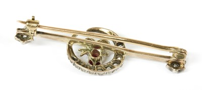 Lot 13 - A gold and silver, diamond, ruby and sapphire crescent bar brooch