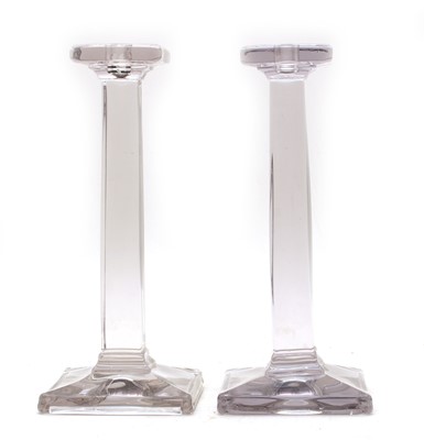 Lot 104 - A pair of contemporary glass candlesticks of angular form