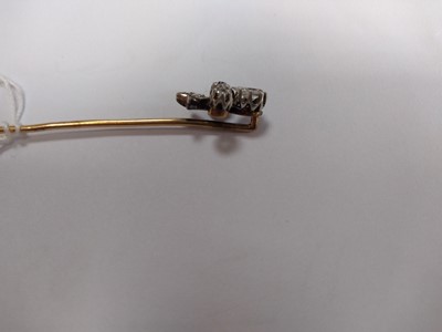 Lot 51 - A cased diamond set fleur-de-lys stick pin, early 20th century