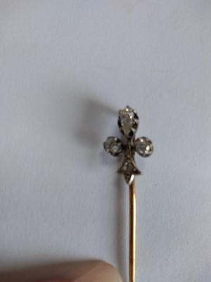 Lot 51 - A cased diamond set fleur-de-lys stick pin, early 20th century