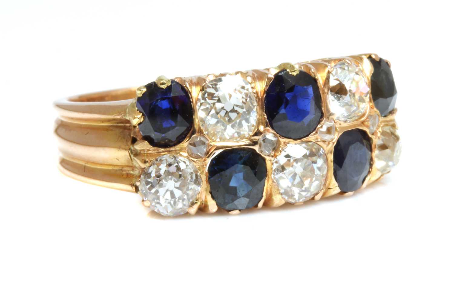 Lot 48 - A rose gold two row sapphire and diamond ring, c.1910