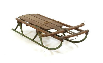 Lot 414 - A cast iron and wooden 'Flexible Flyer' sledge