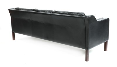 Lot 374 - A black leather three-seater sofa