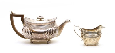 Lot 29 - An Edwardian silver teapot and associated milk jug