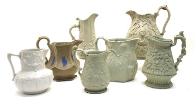 Lot 225 - A large collection of stoneware relief-moulded jugs
