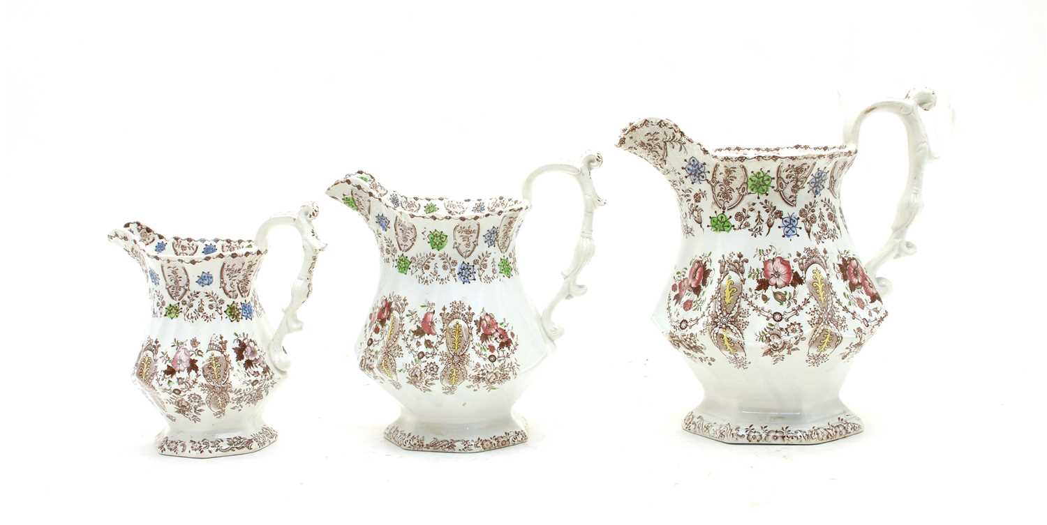 Lot 181 - A graduated set of three Victorian pottery jugs