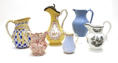 Lot 422 - A collection of twelve pottery jugs