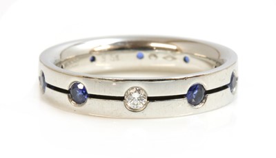 Lot 292 - A Swiss platinum diamond and sapphire set band ring, by Furrer-Jacot