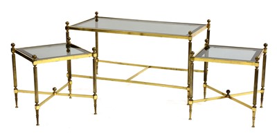 Lot 539 - A nest of three brass tables