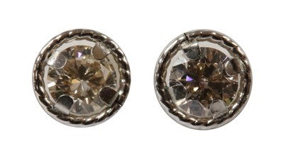Lot 152 - A pair of white gold diamond stud earrings