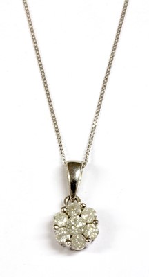 Lot 108 - A white gold diamond daisy cluster pendant