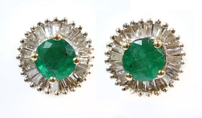 Lot 199 - A pair of gold emerald and diamond cluster earrings
