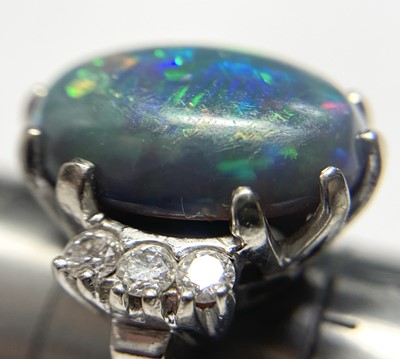 Lot 168 - An American white gold black opal and diamond ring
