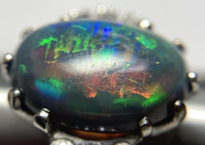 Lot 168 - An American white gold black opal and diamond ring