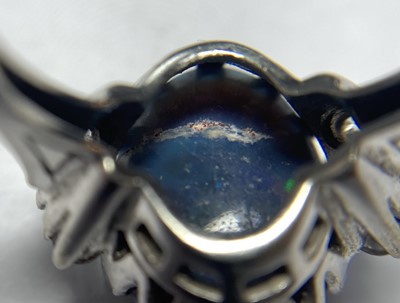 Lot 168 - An American white gold black opal and diamond ring