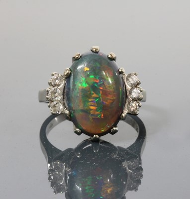 Lot 168 - An American white gold black opal and diamond ring